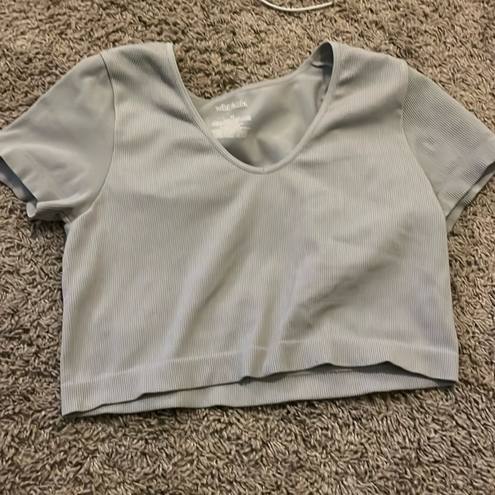 It’s a grey cropped ribbed shirt